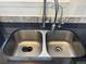 Stainless steel dual sink with a modern faucet and a dark countertop at 8657 Clay St # 383, Westminster, CO 80031