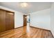 Bedroom with hardwood floors and access to another room at 7025 Newland St, Arvada, CO 80003