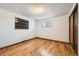 Simple bedroom with hardwood floors and built-in shelving at 7025 Newland St, Arvada, CO 80003