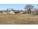 Vast backyard featuring mature trees, shed, covered patio, and ample space for outdoor activities at 8097 E Lehigh Dr, Denver, CO 80237
