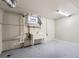 An unfinished basement area with utility sink, concrete floor, and ample space for storage or customization at 8097 E Lehigh Dr, Denver, CO 80237
