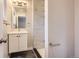 Bathroom featuring updated vanity, mirror, and shower with tile surround at 8097 E Lehigh Dr, Denver, CO 80237