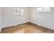 Bedroom with hardwood floors, baseboard, and natural light from two windows at 8097 E Lehigh Dr, Denver, CO 80237
