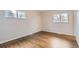 Bedroom featuring refinished hardwood flooring and bright natural light at 8097 E Lehigh Dr, Denver, CO 80237