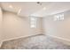 Bright bedroom with gray carpet, natural light from two windows, and fresh paint at 8097 E Lehigh Dr, Denver, CO 80237