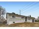 Charming single-story home with a brick facade and well-maintained front yard at 8097 E Lehigh Dr, Denver, CO 80237