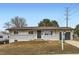 Charming single-story home with a brick facade and well-maintained front yard at 8097 E Lehigh Dr, Denver, CO 80237