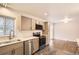 Modern kitchen features stainless steel appliances, stylish countertops, and ample cabinet space at 8097 E Lehigh Dr, Denver, CO 80237