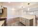 Bright kitchen featuring stainless appliances, a peninsula, and updated flooring at 8097 E Lehigh Dr, Denver, CO 80237