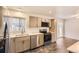 Modern kitchen features stainless steel appliances, stylish countertops, and ample cabinet space at 8097 E Lehigh Dr, Denver, CO 80237