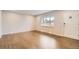 Spacious living room with beautiful hardwood floors and large window for natural light at 8097 E Lehigh Dr, Denver, CO 80237