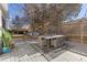 Expansive backyard deck with modern seating and dining, surrounded by mature trees for privacy and shade at 700 Holly St, Denver, CO 80220