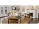 Bright living room featuring a fireplace, hardwood floors and lots of natural light from the french doors at 700 Holly St, Denver, CO 80220