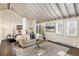 Relaxing main bedroom with lots of light, cozy seating, and a beamed ceiling at 700 Holly St, Denver, CO 80220