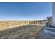 Spacious fenced backyard with a lush grass and gravel landscaping at 45871 Orchid Ave, Bennett, CO 80102