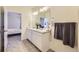Well-lit bathroom featuring double vanity, modern fixtures, and clean, neutral décor at 45871 Orchid Ave, Bennett, CO 80102
