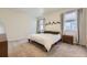 Neutral bedroom featuring large windows with natural light, and minimalist design elements at 45871 Orchid Ave, Bennett, CO 80102