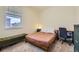 Bright bedroom featuring a window view, desk, chair, and a stylish bench at 45871 Orchid Ave, Bennett, CO 80102