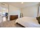 Spacious bedroom with a view into dining space, a dresser, and a standing mirror at 45871 Orchid Ave, Bennett, CO 80102
