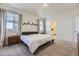 Bedroom with natural light, neutral walls, plush carpet, and simple elegant décor at 45871 Orchid Ave, Bennett, CO 80102