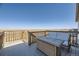 Outdoor deck featuring scenic views, a wicker table, and seating area at 45871 Orchid Ave, Bennett, CO 80102