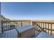 Relaxing deck space with wicker seating, an outdoor table, and scenic views at 45871 Orchid Ave, Bennett, CO 80102