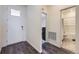 Bright entryway with sleek dark wood flooring, complemented by a view into a bathroom and another room at 45871 Orchid Ave, Bennett, CO 80102