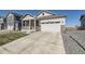Lovely home showcasing a cozy front porch and a spacious two-car garage, ideal for modern living at 45871 Orchid Ave, Bennett, CO 80102