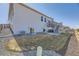 Exterior view of the back of the house, with a deck, patio, and backyard at 45871 Orchid Ave, Bennett, CO 80102