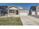 Beautiful house features a welcoming front porch and an attached two-car garage, perfect for a Gathering at 45871 Orchid Ave, Bennett, CO 80102