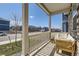 Cozy front porch featuring comfortable seating, perfect for relaxing and enjoying the neighborhood views at 45871 Orchid Ave, Bennett, CO 80102