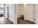 Inviting hallway features hard wood flooring, a shoe rack, and neutral paint colors at 45871 Orchid Ave, Bennett, CO 80102