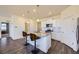 Contemporary kitchen featuring an island with barstool seating, stainless appliances, and stylish flooring at 45871 Orchid Ave, Bennett, CO 80102