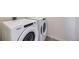 Modern laundry room with a side-by-side washer and dryer at 45871 Orchid Ave, Bennett, CO 80102