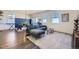 Open-concept living room with a comfortable couch, dining area, and ample natural light from large windows at 45871 Orchid Ave, Bennett, CO 80102