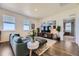 Airy living room featuring modern decor, large windows, and stylish furnishings for comfortable living at 45871 Orchid Ave, Bennett, CO 80102