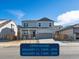 Two-story house with gray siding, stone accents, and a two-car garage at 9147 Pitkin St, Commerce City, CO 80022