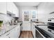 Galley kitchen with granite countertops and white cabinets at 1157 Krameria St, Denver, CO 80220