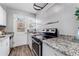 Modern kitchen with granite countertops and stainless steel appliances at 1157 Krameria St, Denver, CO 80220