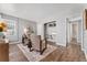 Living room with hardwood floors, built-in shelving, and a view of the bathroom at 1157 Krameria St, Denver, CO 80220