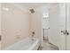 Bright bathroom with a shower and tub combination and an open door to the vanity at 4896 S Dudley St # 8, Littleton, CO 80123
