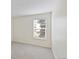 Bright bedroom with window view and neutral colored carpet at 4896 S Dudley St # 8, Littleton, CO 80123