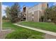 Exterior of a condo building with well-manicured lawn and landscaping at 4896 S Dudley St # 8, Littleton, CO 80123