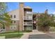 Inviting exterior view of a multi-story condo building with balconies and manicured landscaping in a residential area at 4896 S Dudley St # 8, Littleton, CO 80123
