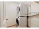 This laundry area features a stacked washer and dryer, as well as wire shelving at 4896 S Dudley St # 8, Littleton, CO 80123