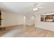 Bright living room with wood floors, fireplace, and a partial view of the kitchen at 4896 S Dudley St # 8, Littleton, CO 80123