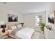 Well-lit bedroom features neutral color palette and window views at 4896 S Dudley St # 8, Littleton, CO 80123