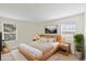 Bedroom featuring natural light, wood furniture, and large decorative wall art at 4896 S Dudley St # 8, Littleton, CO 80123