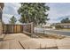 Backyard featuring a wooden fence and mature trees providing shade and privacy at 8770 Rainbow Ave # B4, Denver, CO 80229