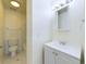 Bright bathroom featuring a white vanity, mirror, and a view into the shower/tub area at 8770 Rainbow Ave # B4, Denver, CO 80229
